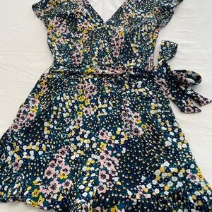 Size M Loft romper. Ruffle floral trim on shorts hem. V neck, petal sleeves.